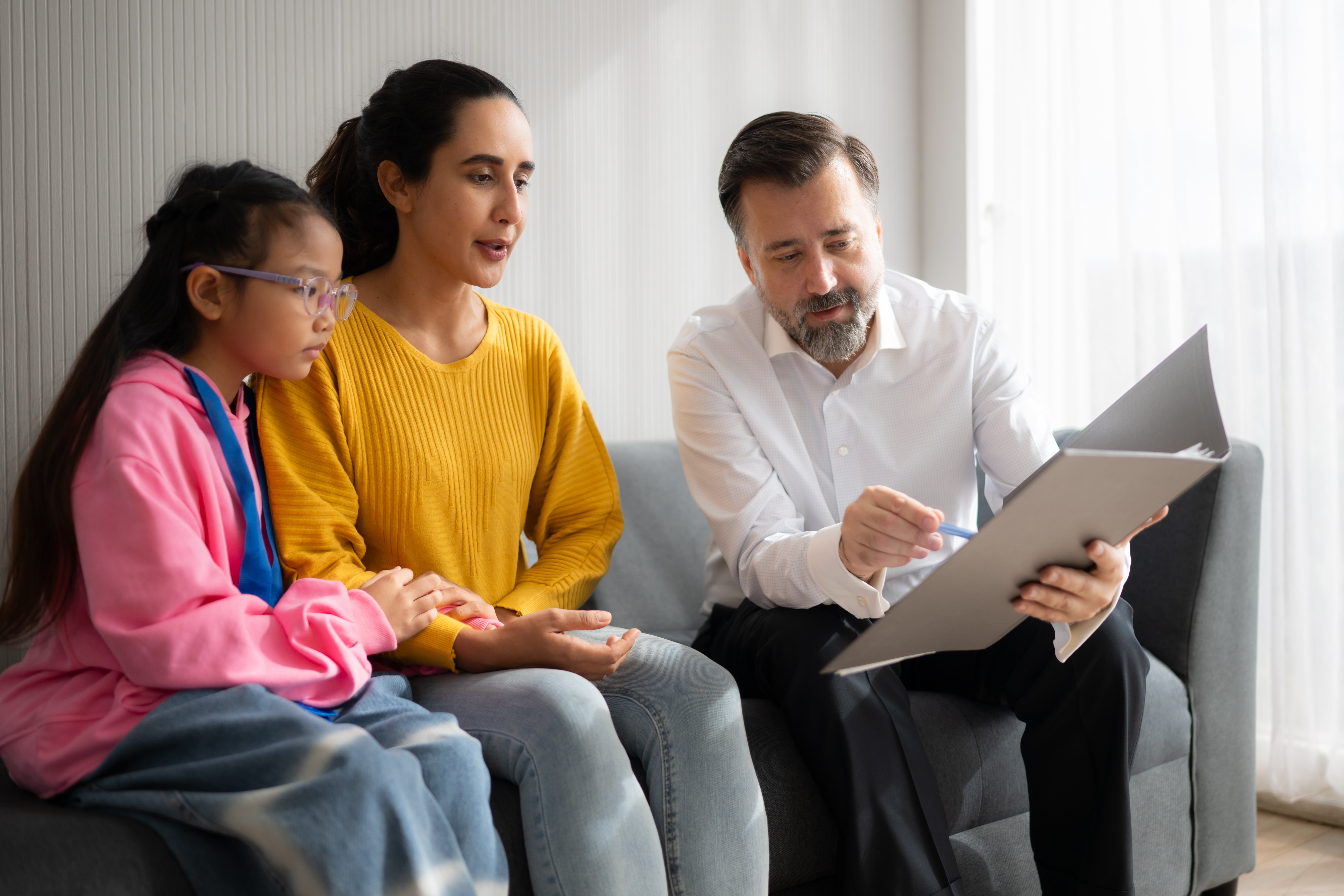 Psychotherapist working with child patient and mother in office, Concept of psychotherapy